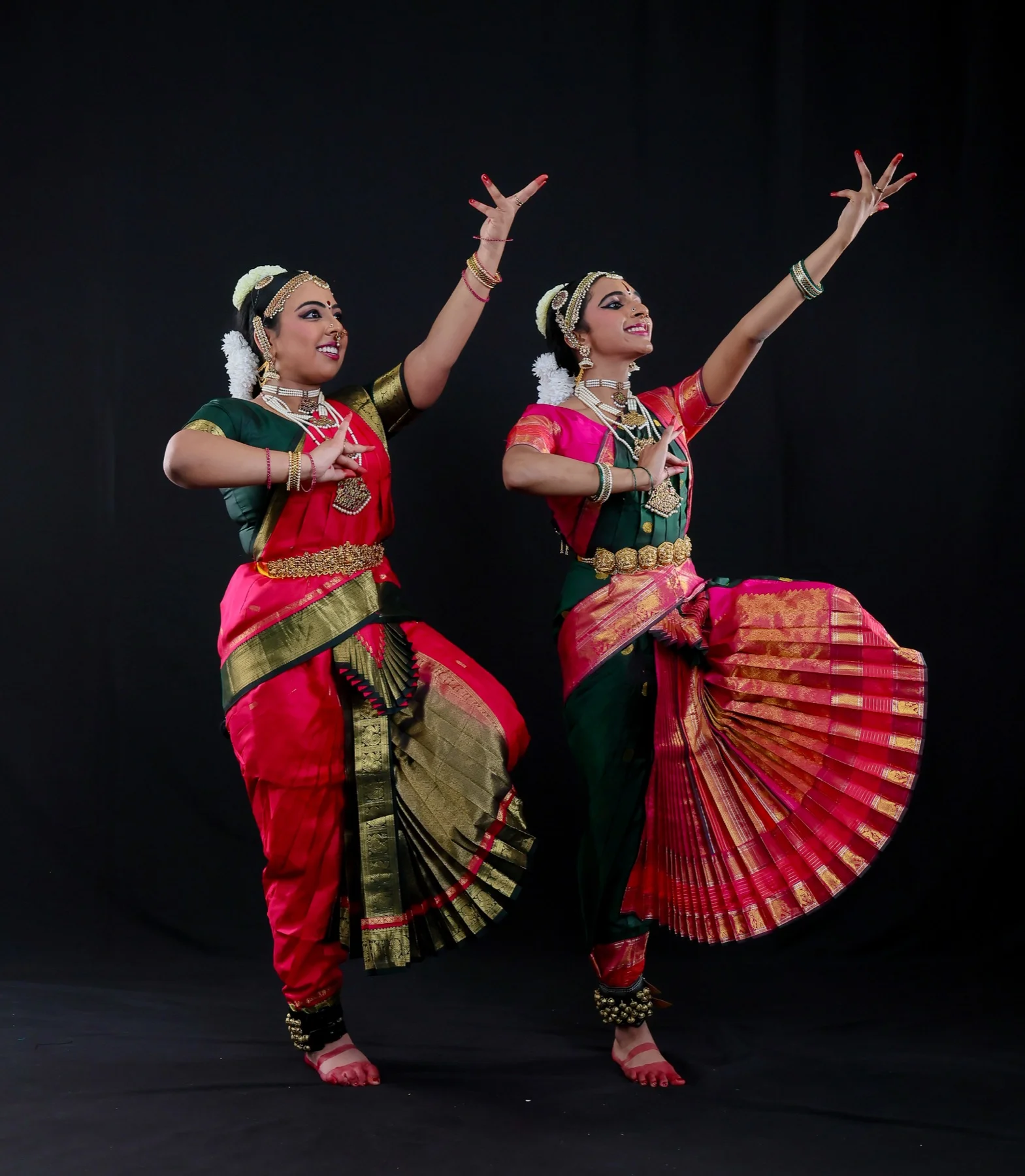 Shreya and Shriya in a wide celebratory Bharatanatyam pose
